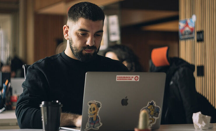 A male employee using faxing software with enhanced security and privacy features