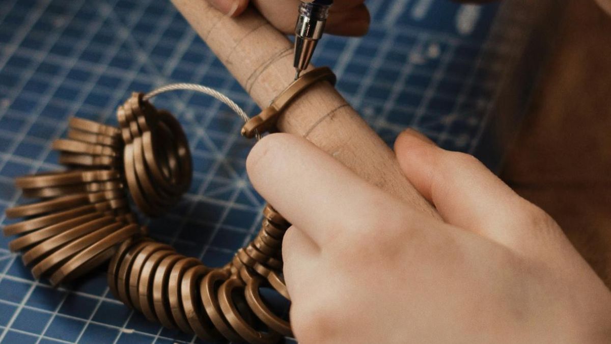 Person measuring finger with ring sizer tool for accurate ring sizing