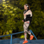 woman wearing headphones running on stairs