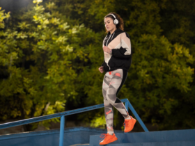 woman wearing headphones running on stairs