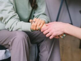 Two women holding hands in support, symbolizing care and guidance during comprehensive addiction treatment programs for recovery success.
