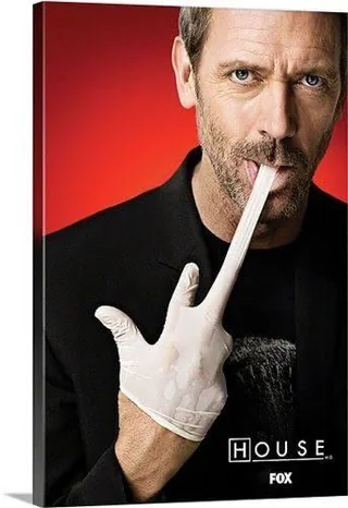 Dr. House making a funny face while stretching a glove with his mouth — one of the top 20 funny pictures online