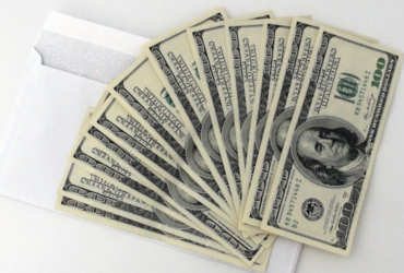 Stack of 100 US dollar bills representing generational wealth