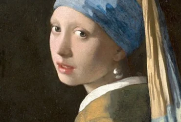 Girl with a Pearl Earring by Johannes Vermeer, a famous 17th-century painting depicting a young woman in an exotic turban with a large pearl earring, known for its captivating gaze and masterful use of light.