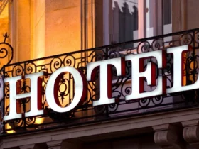 Hotel word on a iron grill outside big building, use to demonstrate Is HOTEL Really an Acronym?