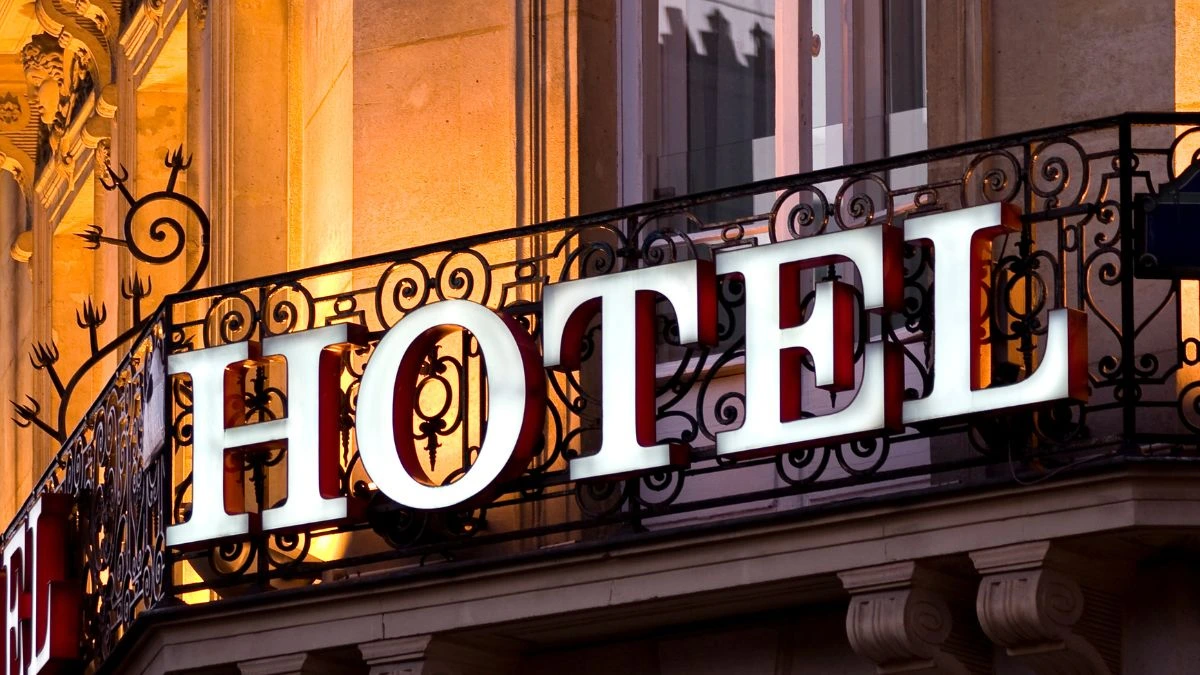 Hotel word on a iron grill outside big building, use to demonstrate Is HOTEL Really an Acronym?