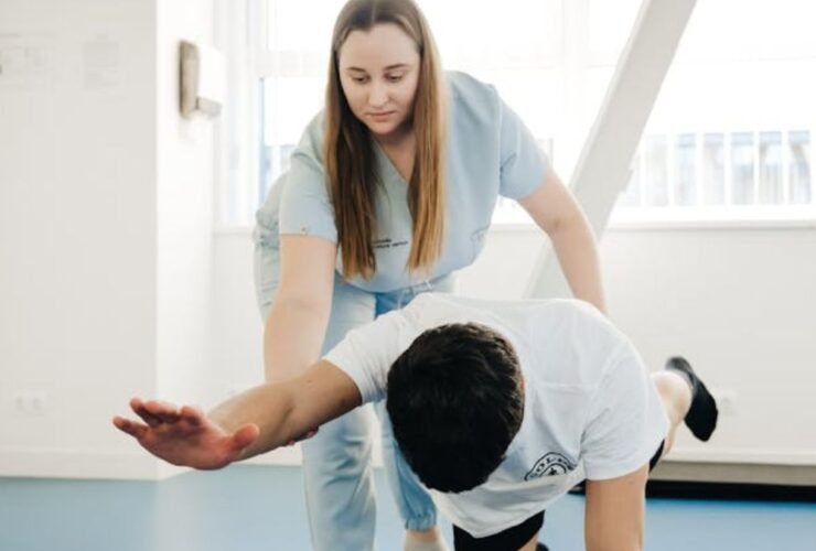 Physiotherapist assisting a man with exercises