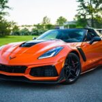 Photo by Garvin St. Villier - red sports car on a fancy road