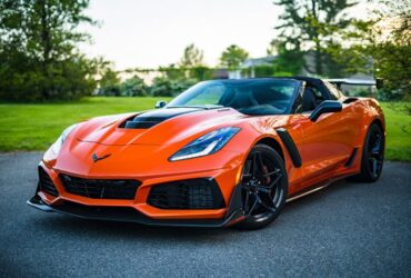 Photo by Garvin St. Villier - red sports car on a fancy road