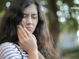 Shallow Focus on a teeth pain Photo of Woman in White and Black Stripe Shirt