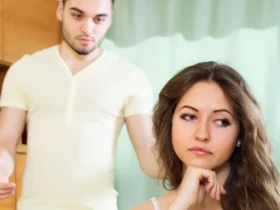 Couple having serious talking in living room - Telling my wife my childhood friend will never forgive her for what she did AITA