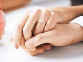 Close-up of a couple holding hands with an elegant diamond engagement ring, showcasing top diamond cut types.
