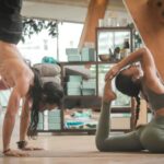 Photo by Carl Barcelo on Unsplash - woman stretching Two people doing yoga