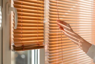 Woman Opening Blinds on Window