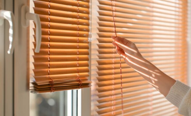 Woman Opening Blinds on Window