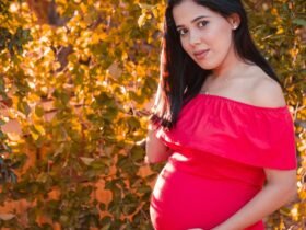 Pregnant woman in red dress representing human voice and storytelling in modern audio media