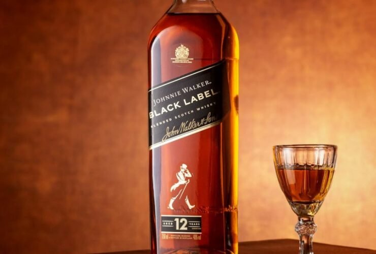Branded bottle and glass showcasing business drinkware