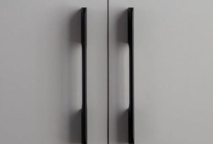 Close-up of brushed brass cabinet handles in modern home design