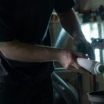 Man checking car fluids under the hood