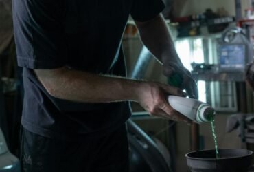 Man checking car fluids under the hood