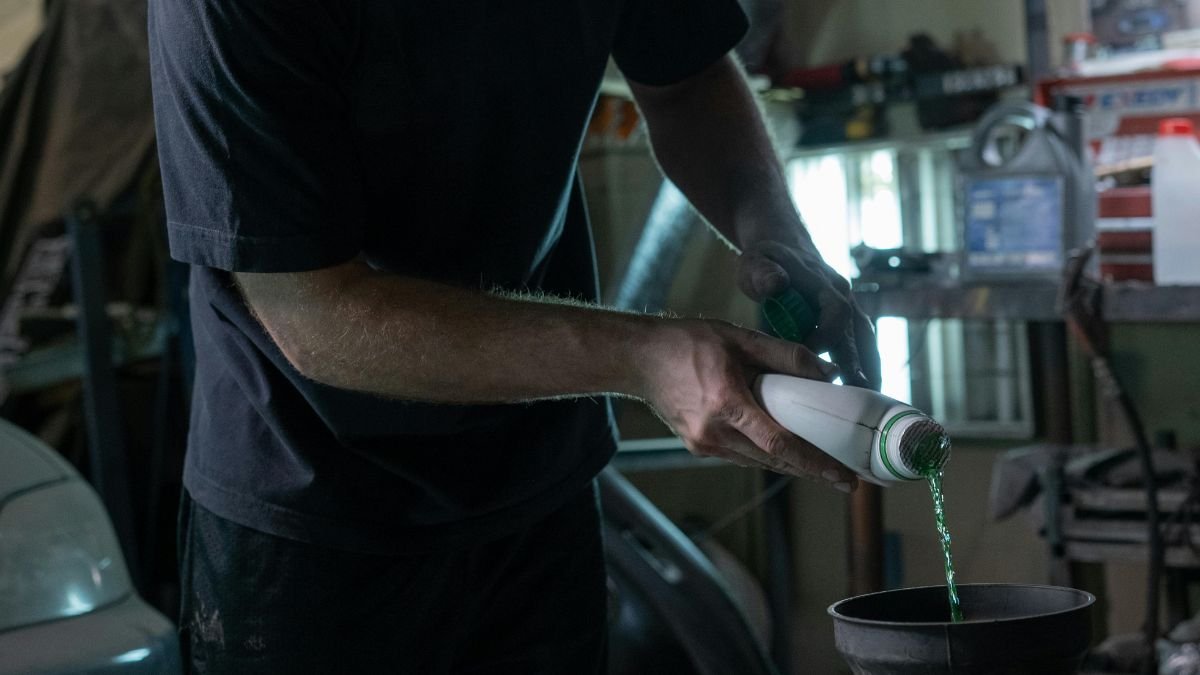 Man checking car fluids under the hood