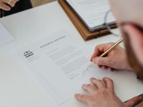 Person signing legal documents at a law firm