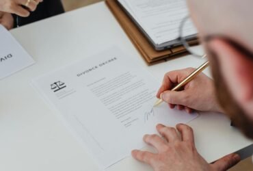 Person signing legal documents at a law firm