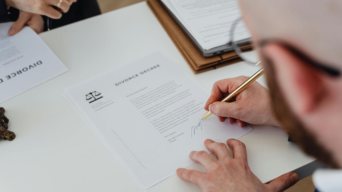 Person signing legal documents at a law firm