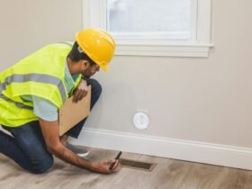 Contractor inspecting electrical socket in a modern home interior