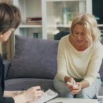 Two women talking during a mental health consultation session