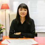Woman reviewing business signage design at a table