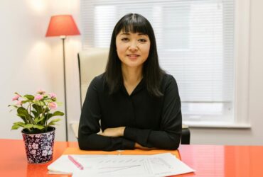 Woman reviewing business signage design at a table