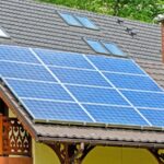 blue solar panels installed on tiled roof