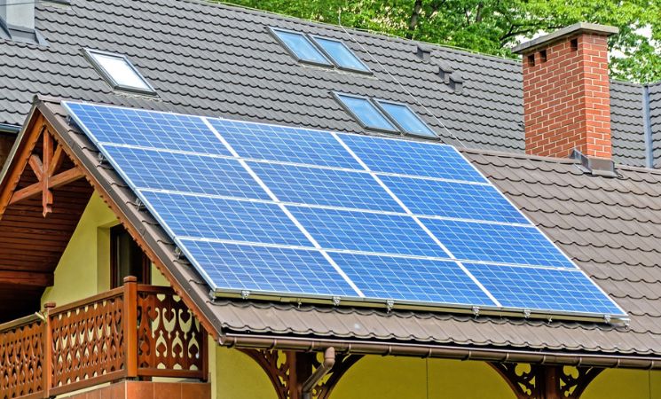 blue solar panels installed on tiled roof