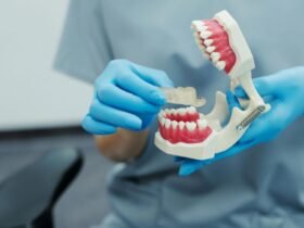 Person holding a dental model highlighting jaw discomfort awareness