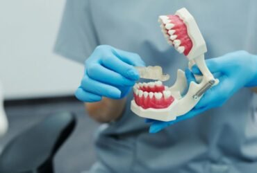 Person holding a dental model highlighting jaw discomfort awareness