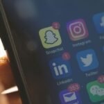 Smartphone screen showing social media apps for brand media alerts