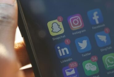 Smartphone screen showing social media apps for brand media alerts