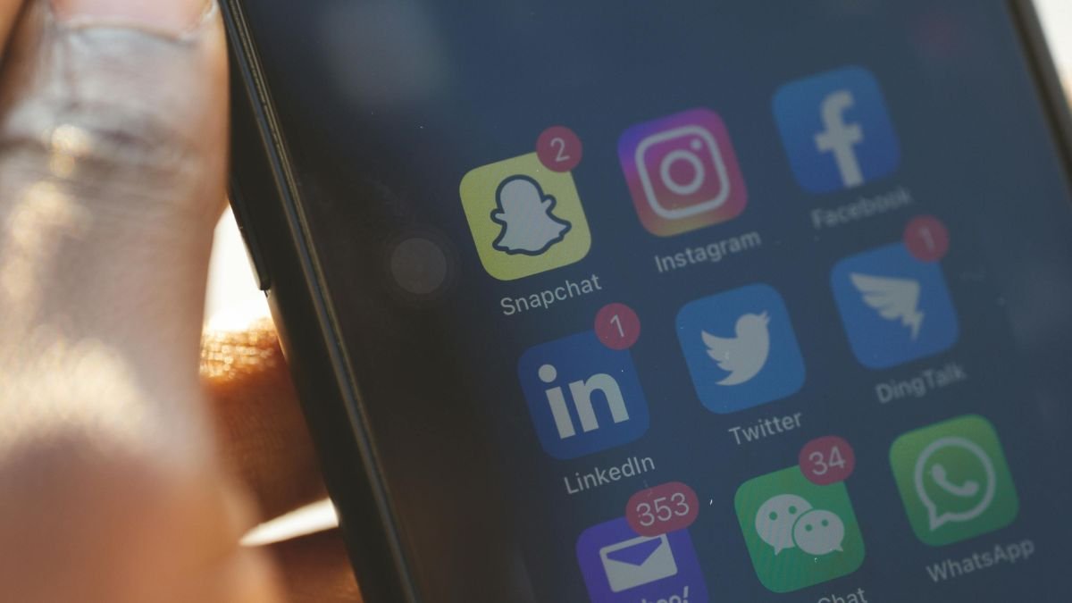 Smartphone screen showing social media apps for brand media alerts