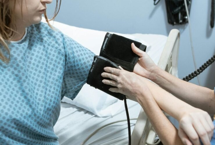 Nurse taking blood pressure of a patient in a clinical setting