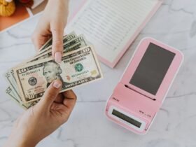 Hands holding dollar bills representing financial planning and EMI calculation