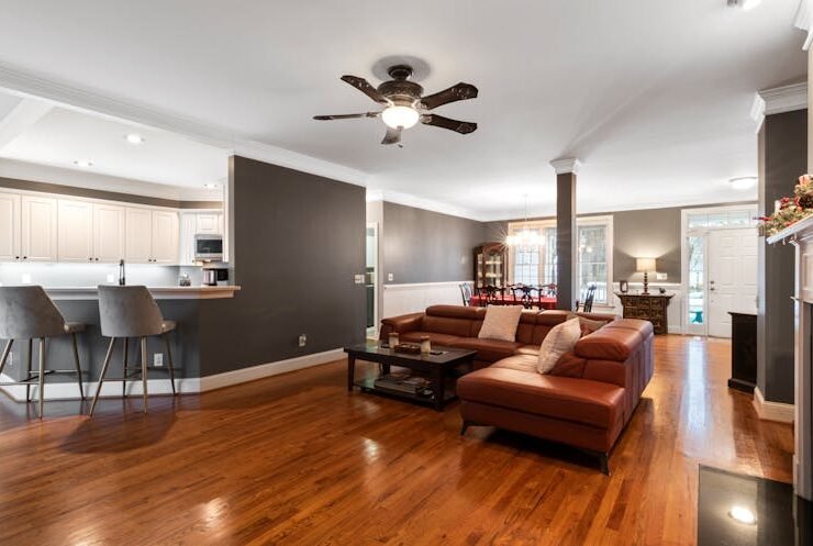 Cozy living room with a brown leather sofa making smart use of limited space