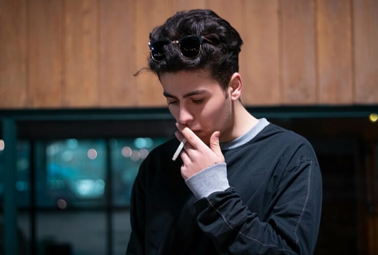 Wealthy man smoking alone in deep thought