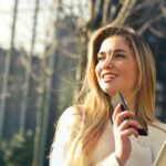 Photo by Andrea Piacquadio - Woman Wearing White Top Holding Smartphone and Tablet finding Real Estate School in Texas