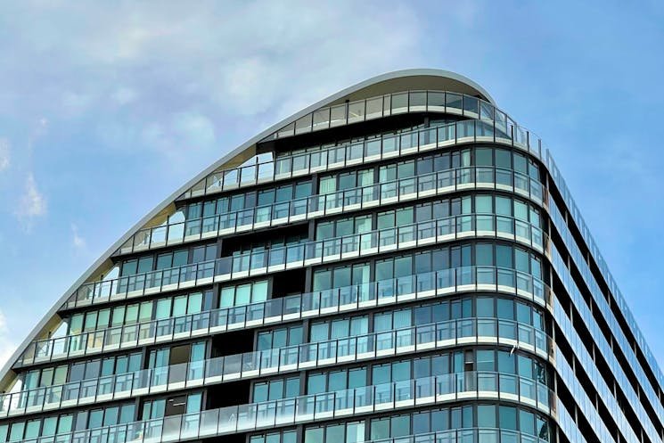 Modern buildings under a blue sky, representing the importance of comprehensive property reports in navigating the Australian real estate market.