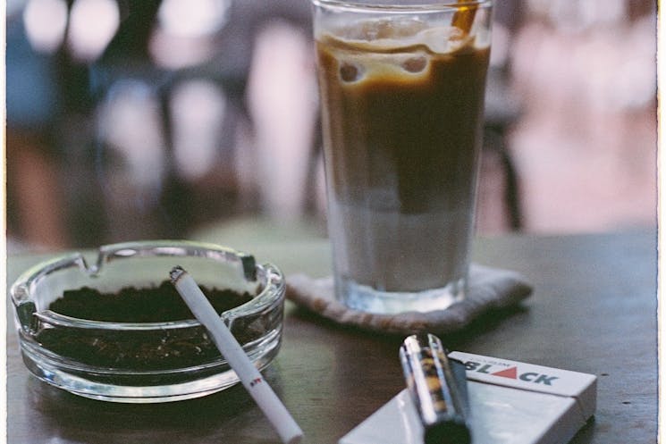 Close-up of a coffee and cigarette symbolizing addiction habits and the struggle to break free