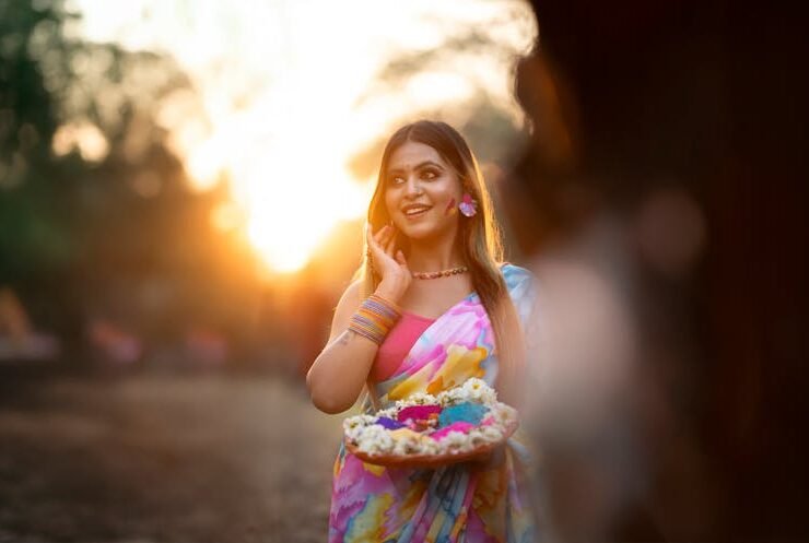A woman celebrating Holi festival with vibrant colors, symbolizing the rich hues of pitaya powder.