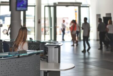 Photo by PhotoMIX Company - IT Manager Sitting Behind Counter Under Television