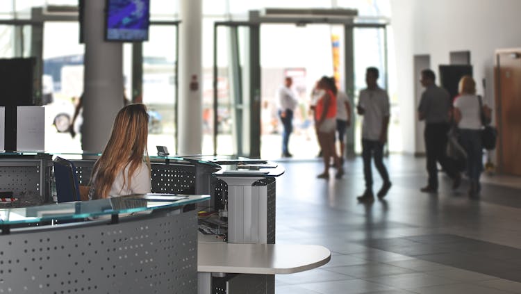 Photo by PhotoMIX Company - IT Manager Sitting Behind Counter Under Television