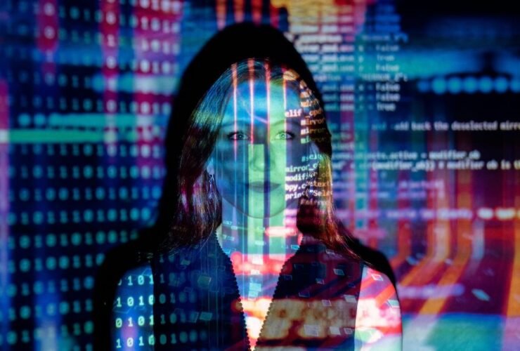 Woman analyzing digital code projections for podcast data monitoring